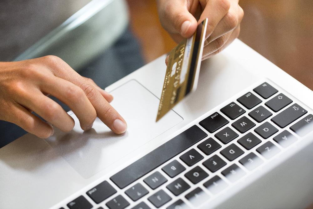 close up of credit card with laptop | bellevue dental office